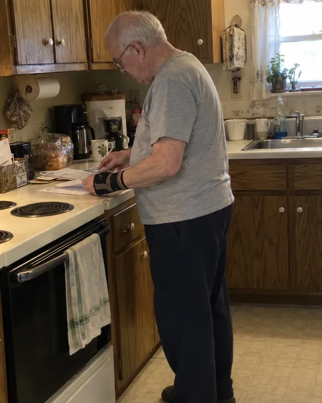 Harold wearing a wrist compression sleeve in his kitchen